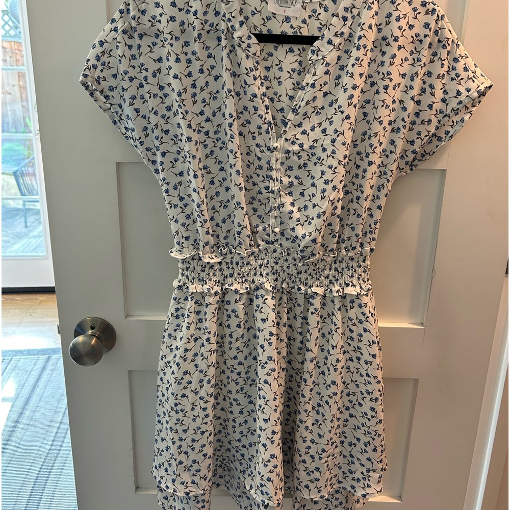White dress with blue floral print. Smocked waist line with tiered skirt. Size S